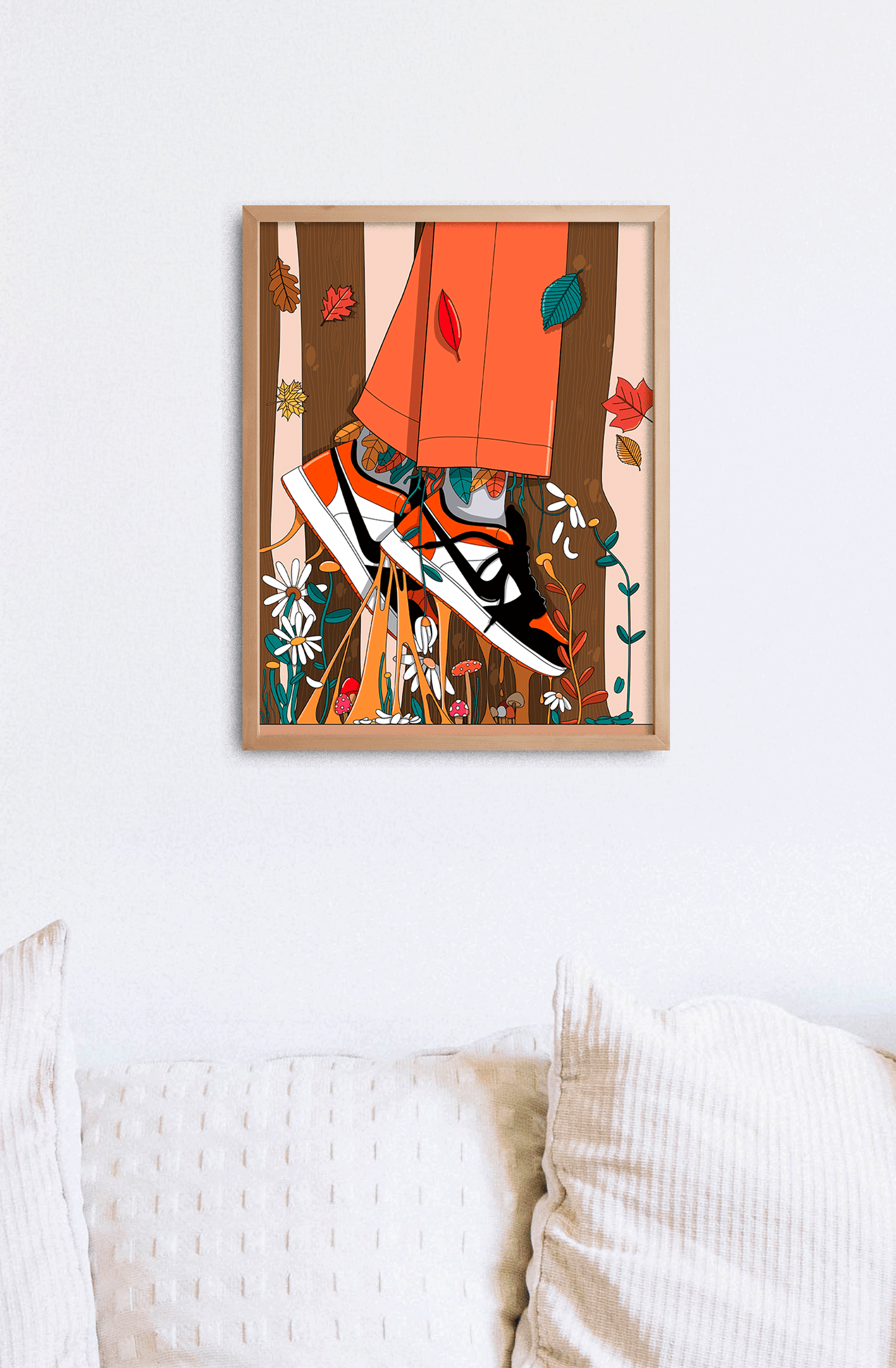 Affiche Air d'automne tenue dans son cadre noir, fond rose fuchsia et canapé orange